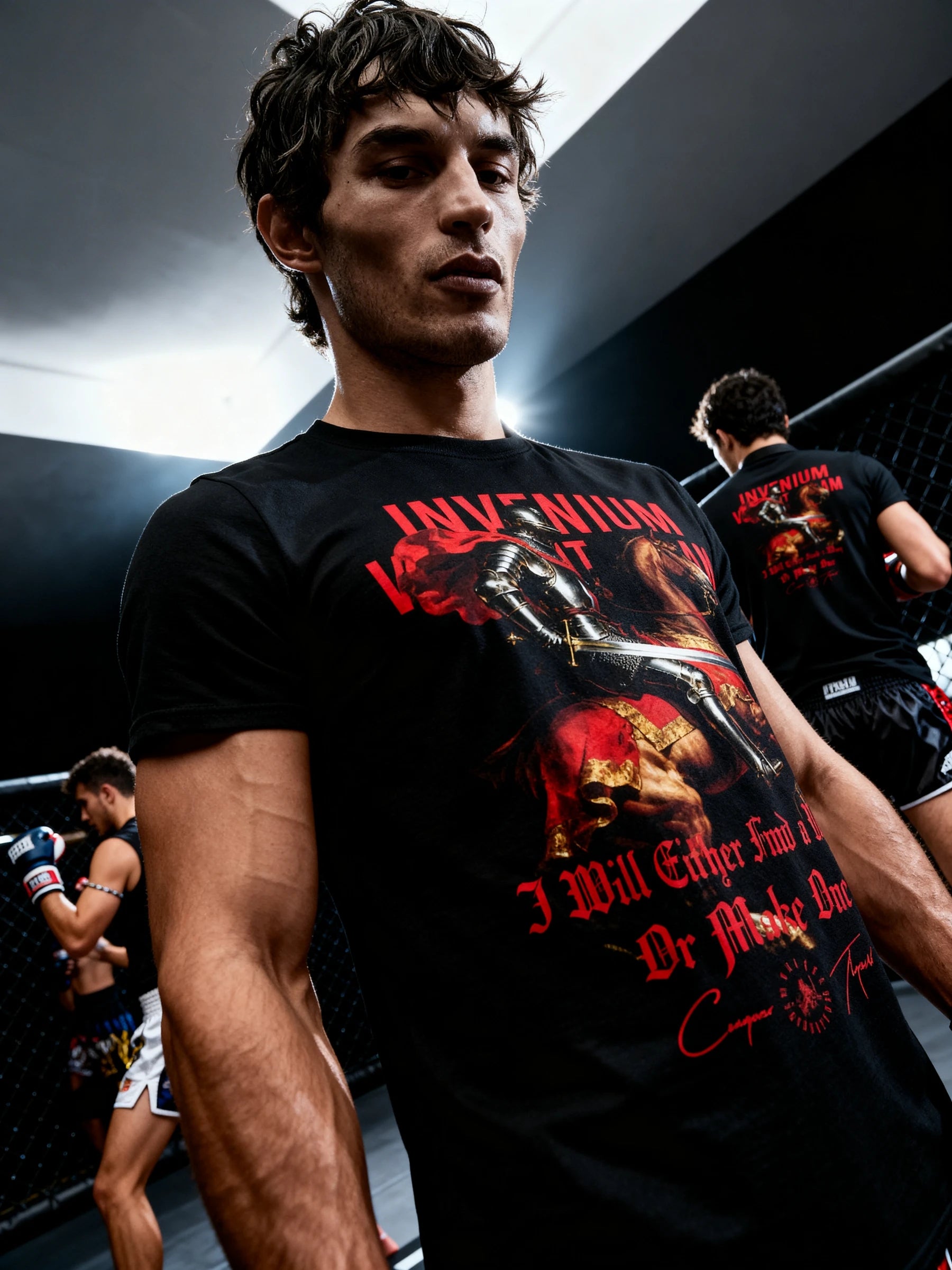 Men's medieval knight gym shirt – model in Invenium Viam Aut Faciam tee in sports arena, workout shirts for men.