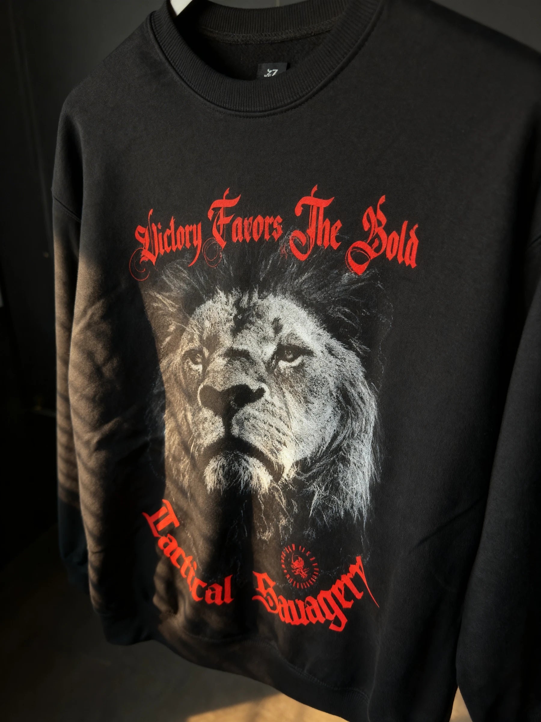 black sweatshirt – black lion crewneck close up, red stoic Victory Favors The Bold text detail – Warface Athletics