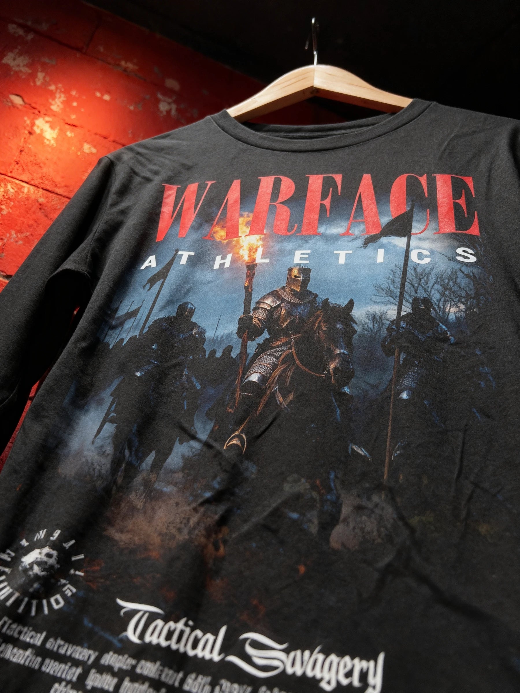 Medieval knight long sleeve gym shirt close-up on hanger – Warface Athletics british knight graphic, red brick wall.