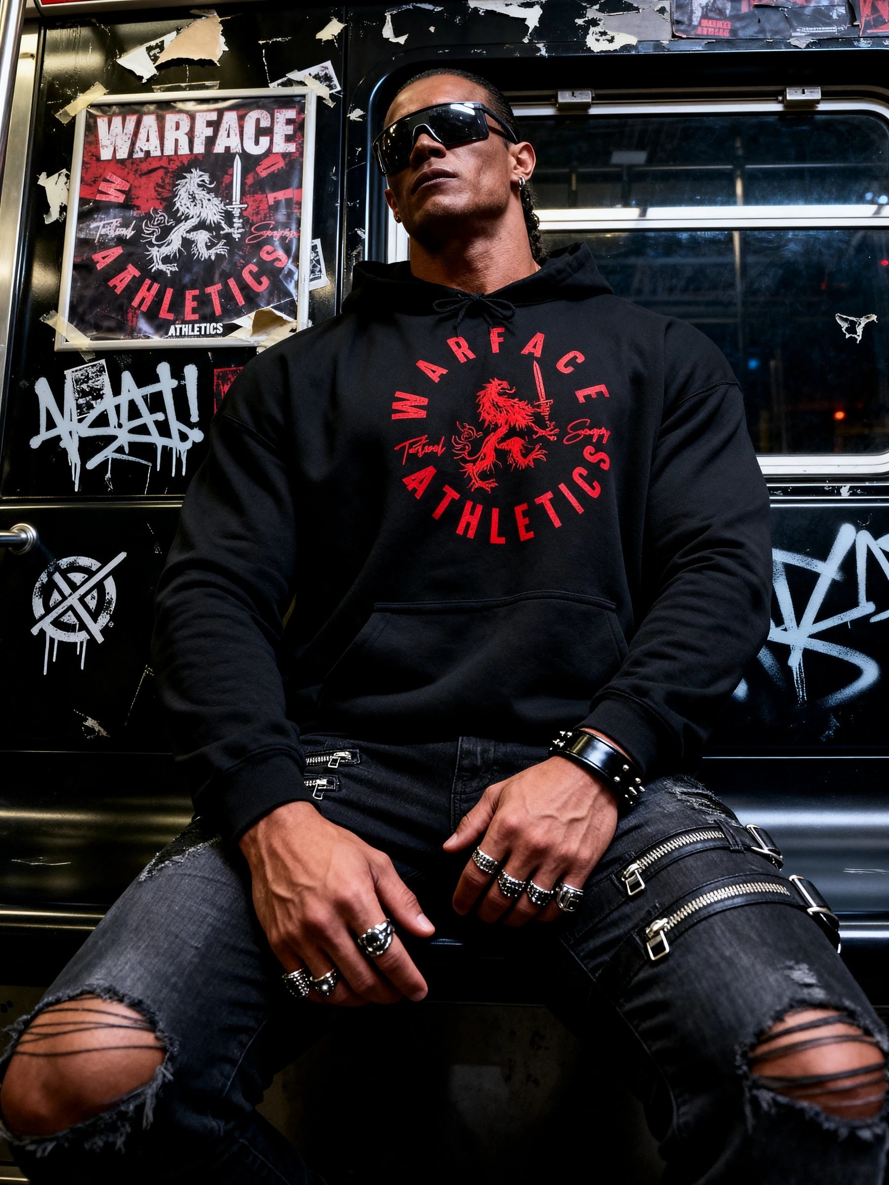 Men's lion graphic gym hoodie – model in Victory Favors The Bold hoodie in urban train setting, streetwear lifestyle.