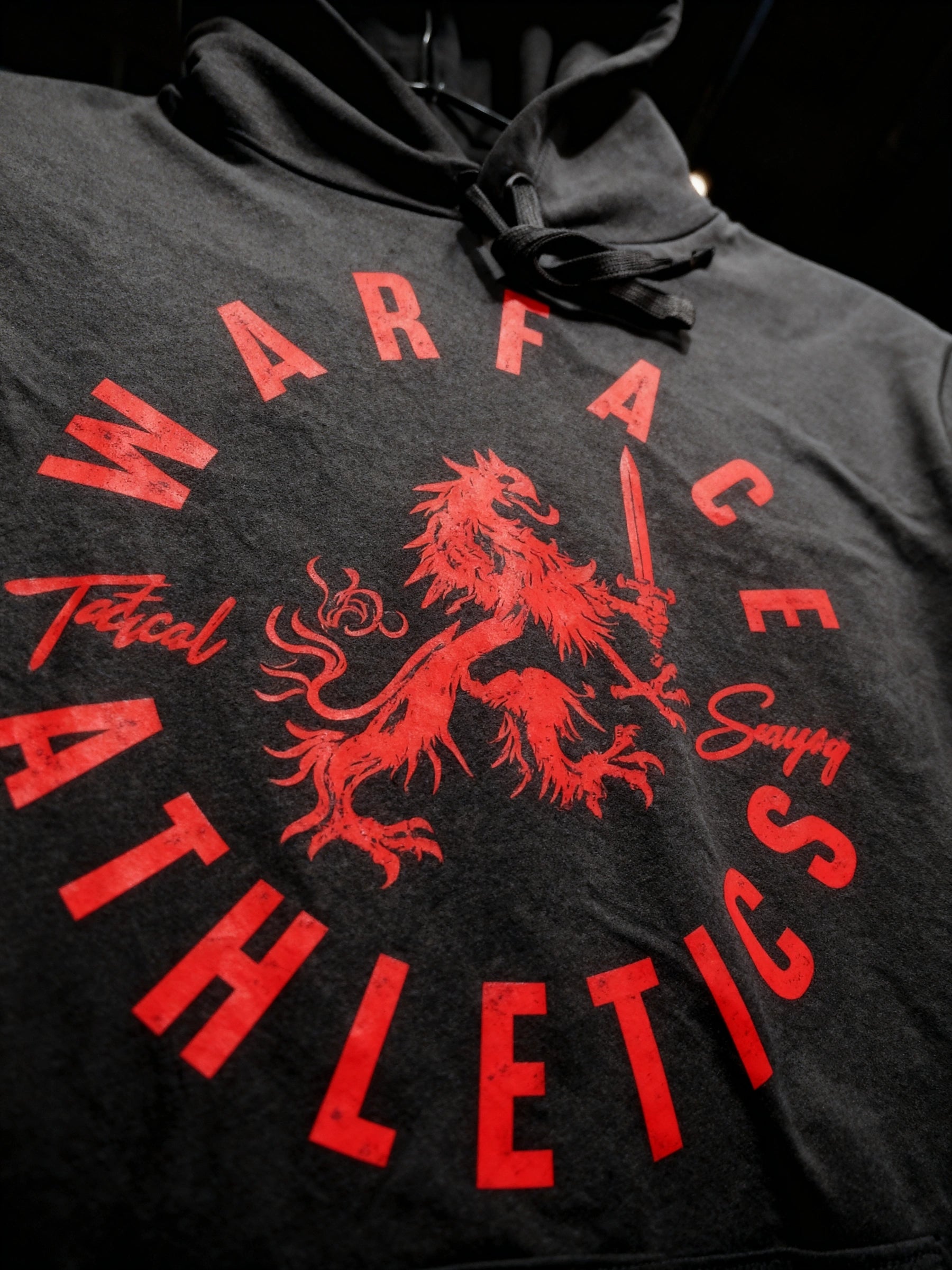 Tactical Savagery heraldic lion hoodie close-up – Warface Athletics red circle crest back print, men's gym hoodie.