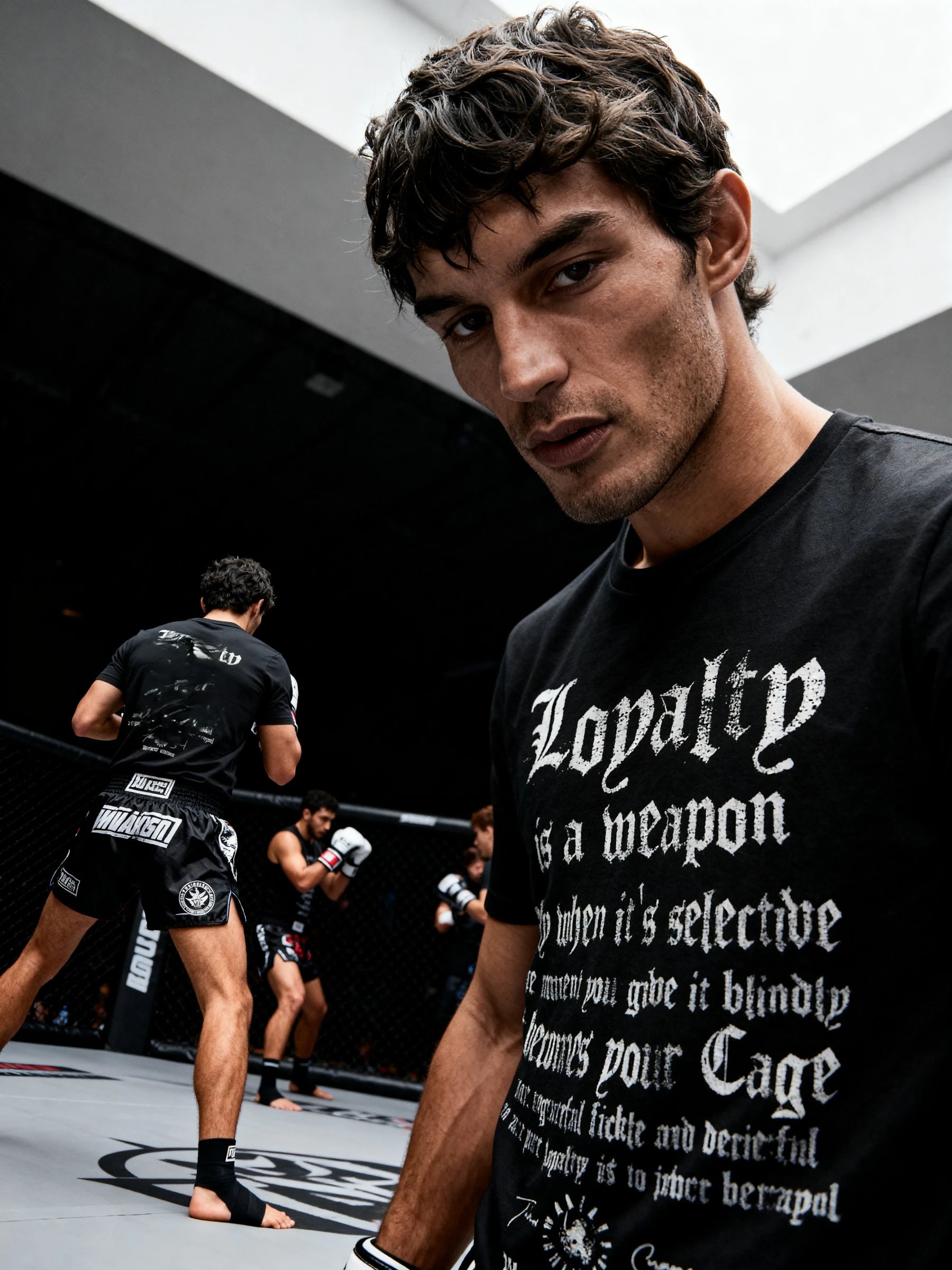 Loyalty Graphic Tee Lifestyle — Men's Stoic Warrior Shirt with Loyalty Quote in Arena Setting by Warface Athletics