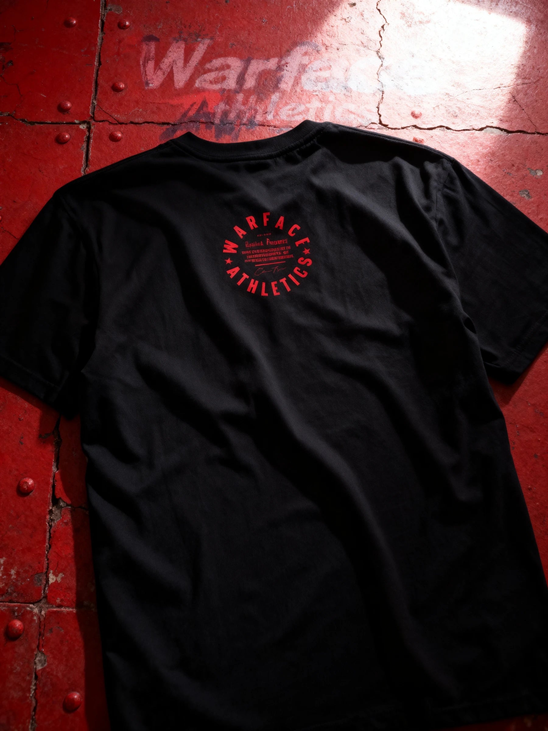 Black athleisure t-shirt with red Warface Athletics logo on a red textured surface