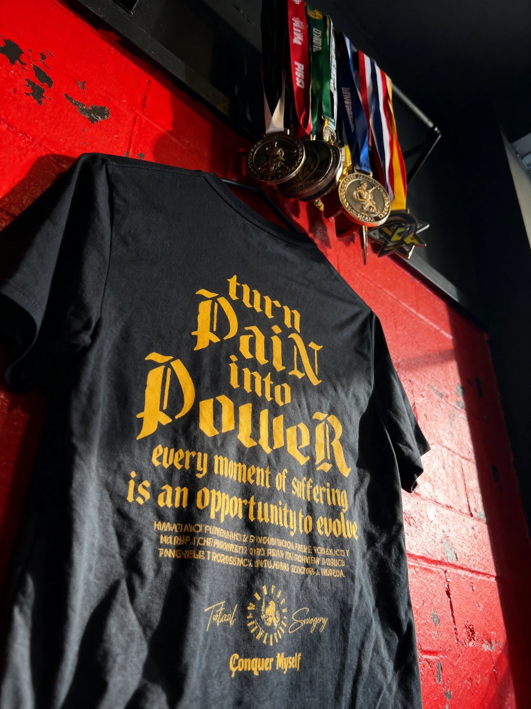 Turn Pain into Power Tee Lifestyle — Men's Stoic Gym Shirt with Yellow Gothic Quote in Urban Setting by Warface Athletics