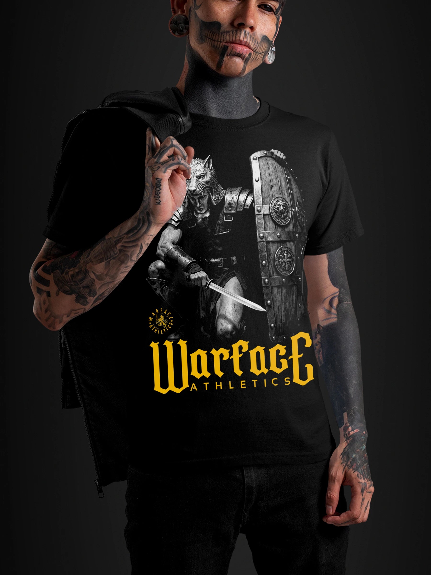 Men's Lone Wolf Gladiator gym shirt – tattooed model in Roman signifer graphic tee, dark background. Warface Athletics.
