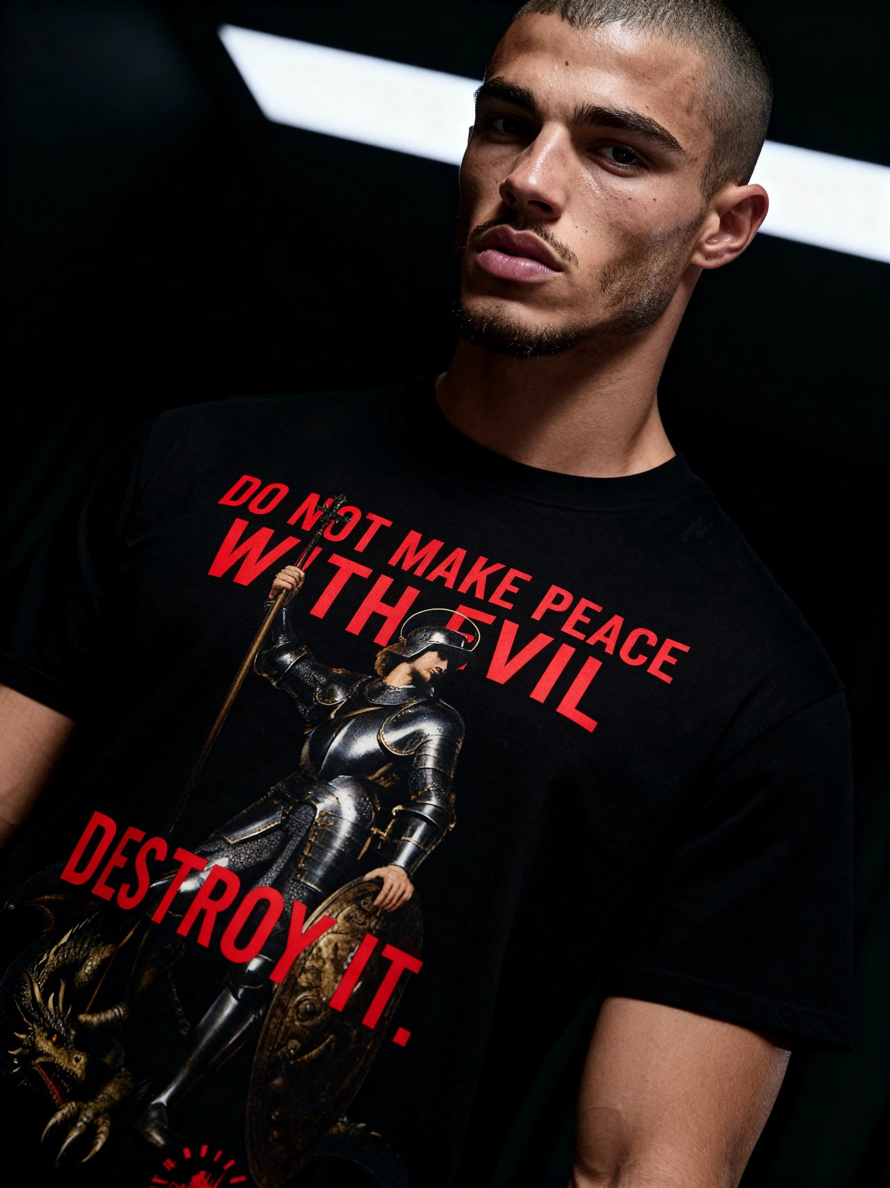 Streetwear model wearing a black St George knight t-shirt with a dragon graphic design and stoic text.