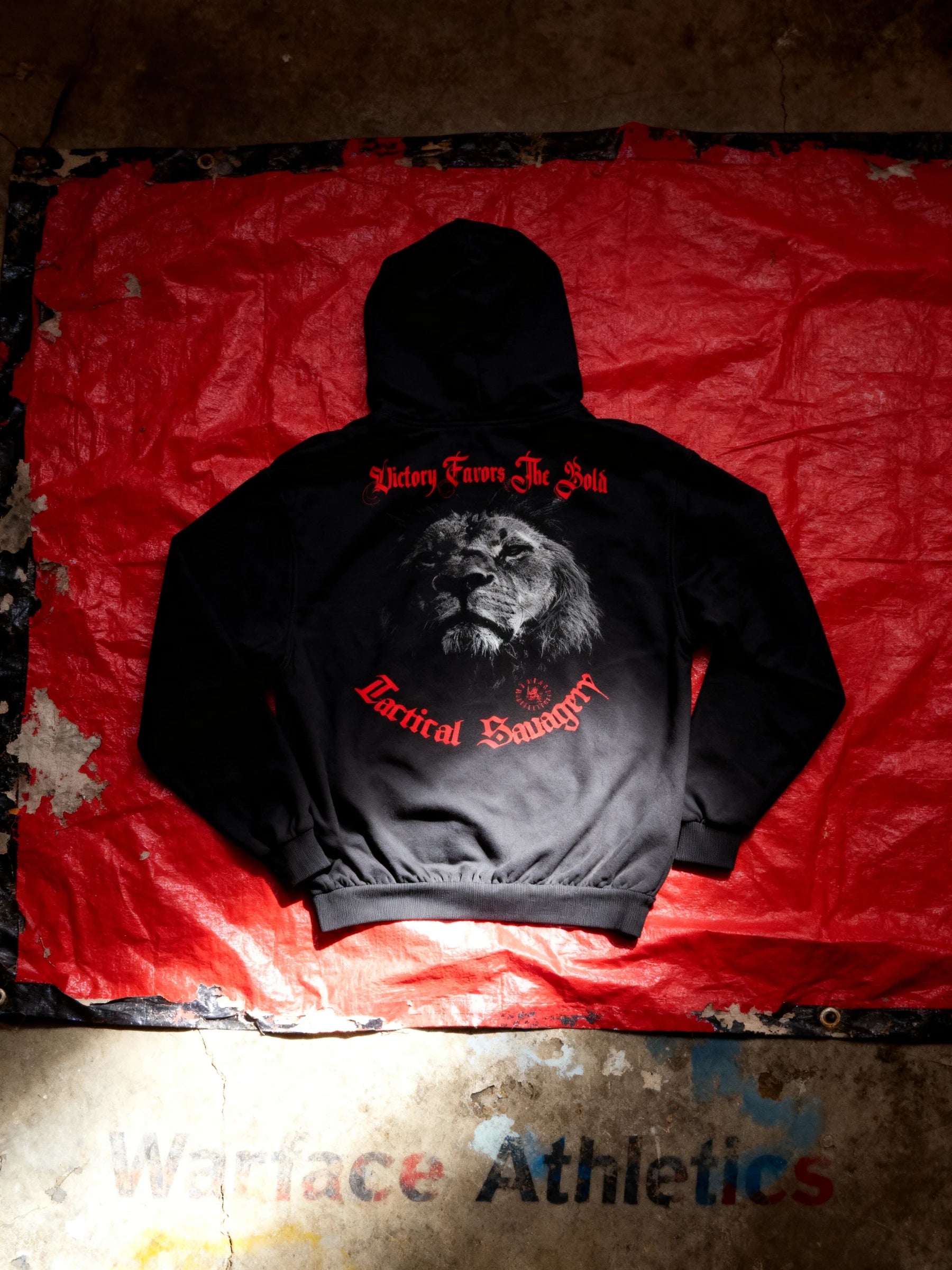 Victory Favors The Bold lion hoodie back print on red surface – men's black graphic gym hoodie detail. Warface Athletics.