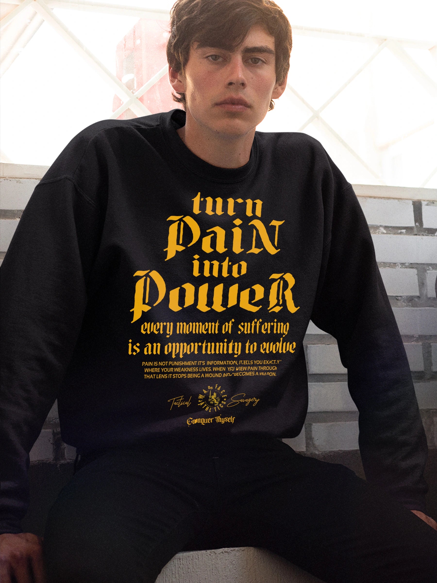 Men's Turn Pain Into Power pump cover sweatshirt – model in stoic typography crewneck on bench, gym sweatshirt for men.