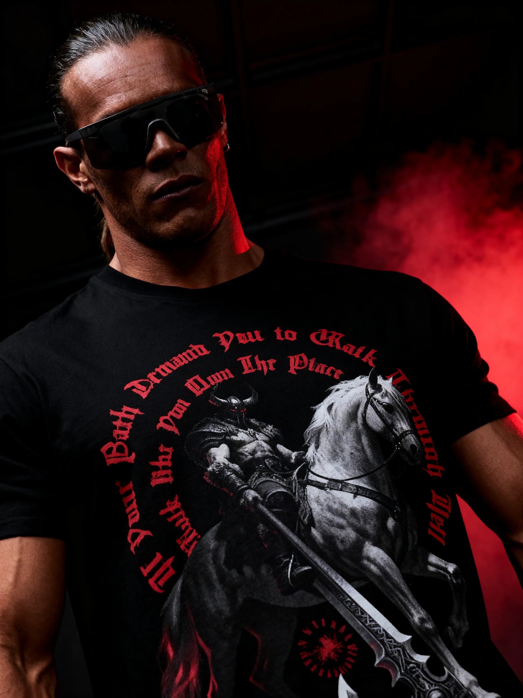 Men's viking graphic gym shirt – model in Walk Like You Own The Place heavyweight tee, red gothic arched text detail.