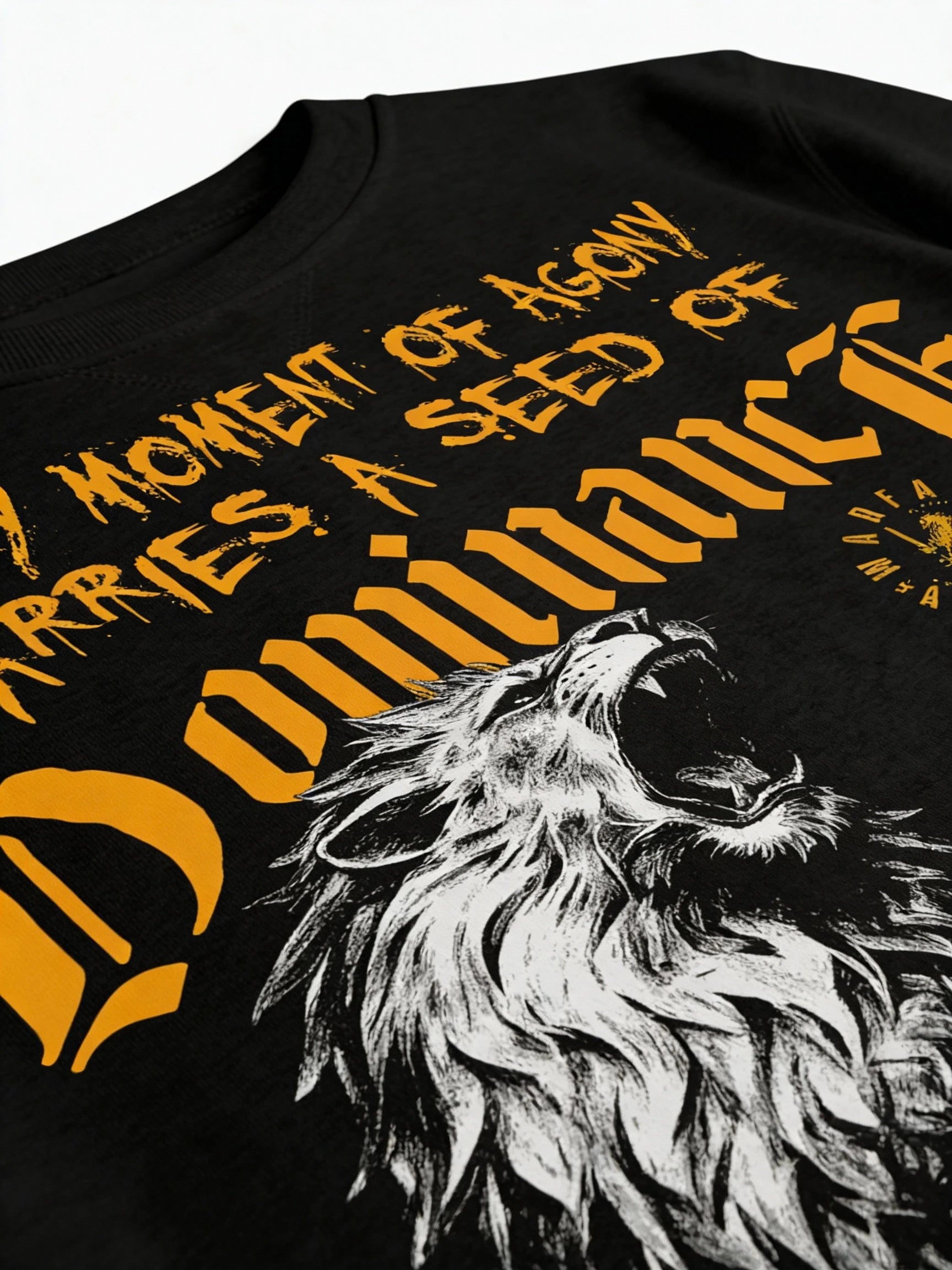 Dominance lion graphic sweatshirt close-up – roaring lion aggressive stance, yellow gothic Every Moment of Agony text detail.