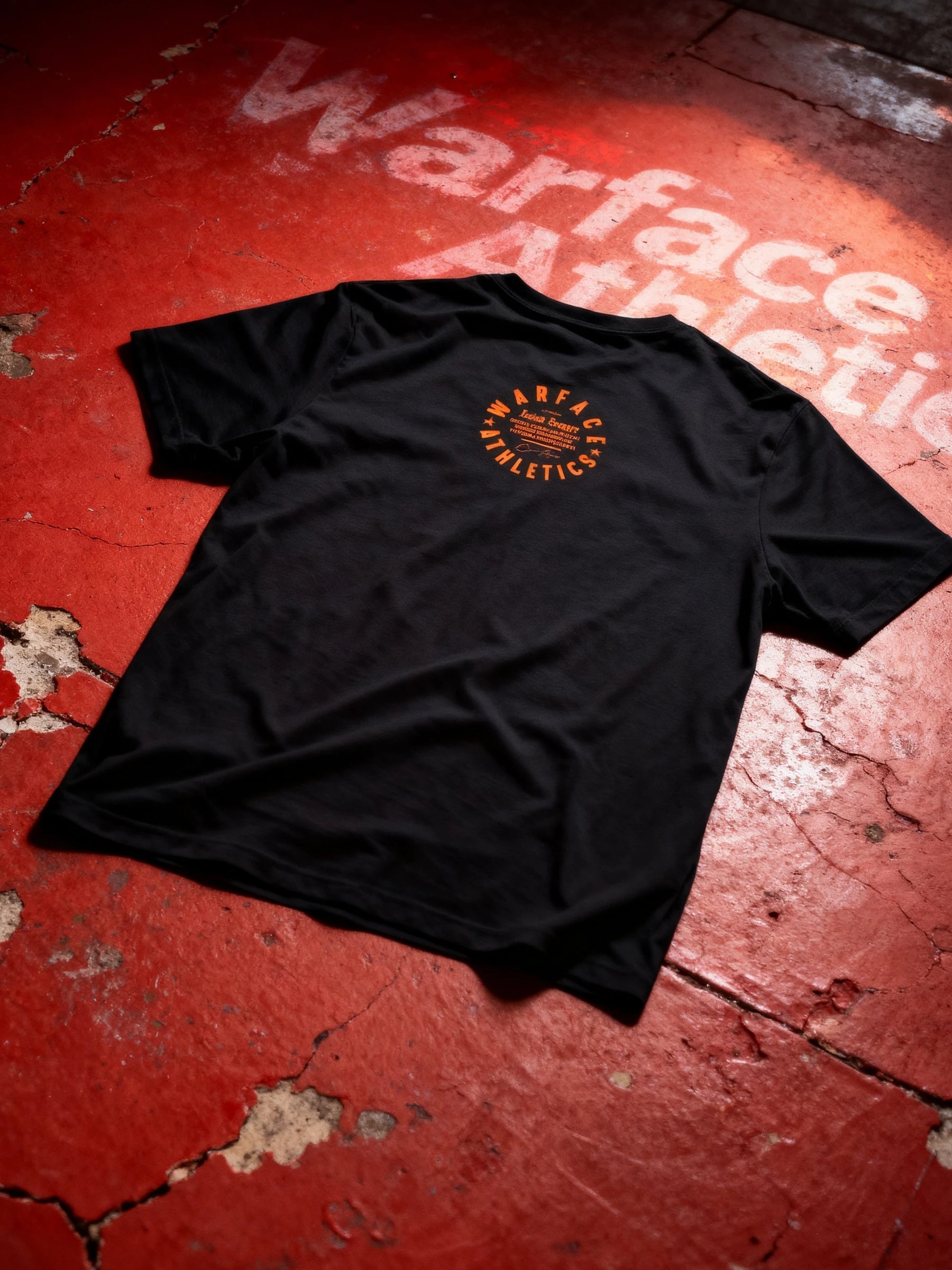 Black t-shirt with a Warface Athletics gym logo on a red textured surface