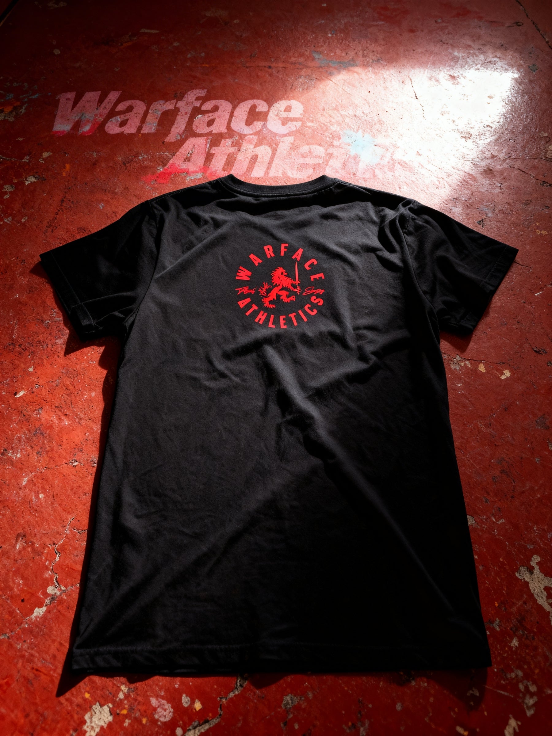warface athletics brand red heraldic lion logo on back of a black gym tee